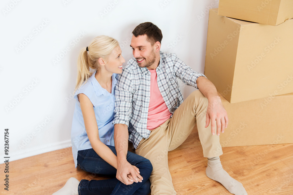 Poster couple with cardboard boxes moving to new home