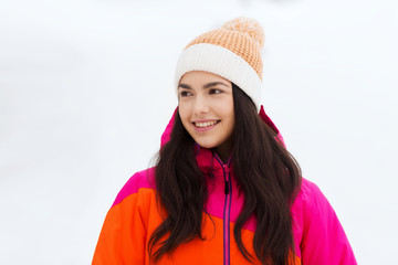 happy young woman in winter clothes outdoors