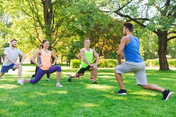 group of friends or sportsmen exercising outdoors