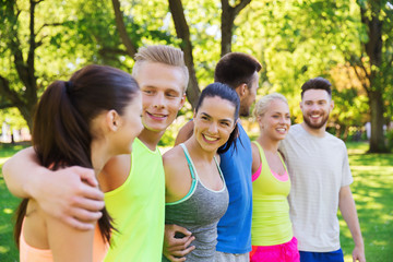 group of happy friends or sportsmen outdoors