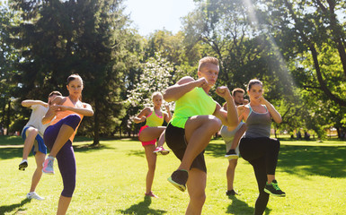 group of friends or sportsmen exercising outdoors