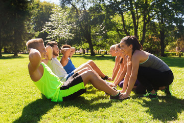 group of friends or sportsmen exercising outdoors