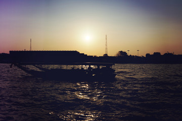 Obraz premium River boats crossing the Chao Phraya river in Bangkok, Thailand. with light leak filter.