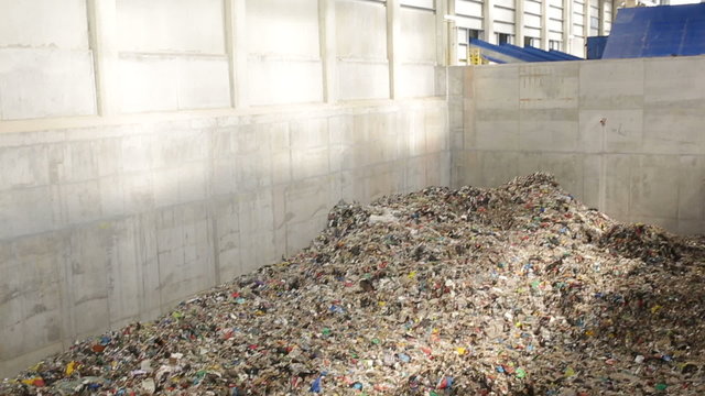 Inside of a new modern waste plant. Pile of waste rwady to be processed in energy.