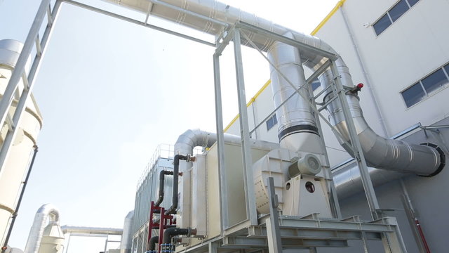 New modern industrial waste plant pipelines from the outside. Waste-to-energy plant. Produces a combustible fuel commodity, such as methane, methanol, ethanol and synthetic fuels.