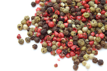 mix of peppercorns over white background