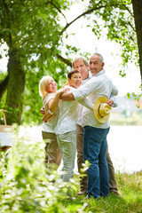 Fototapeta premium Lachende Familie umarmt sich im Garten