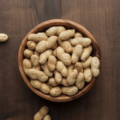 peanuts in wooden bowl on the table