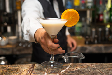 Barman at work, preparing cocktails. Serving pina colada. concept about service and beverages.