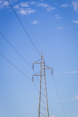 electrical post by the road with power line cables,