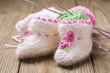 Baby booties with their hands, closeup