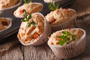 Tasty muffins with ham and cheese close-up. Horizontal
