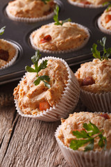 Tasty muffins with ham and cheese close-up. vertical

