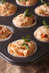 muffins with ham and cheese in baking dish close up. Vertical
