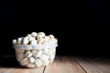 Pistachio put in bowl and place on wood floor