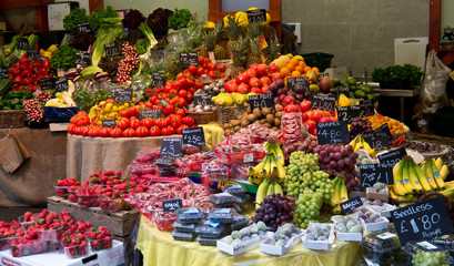 Fruits and vegetables for sale at a grocery market stall