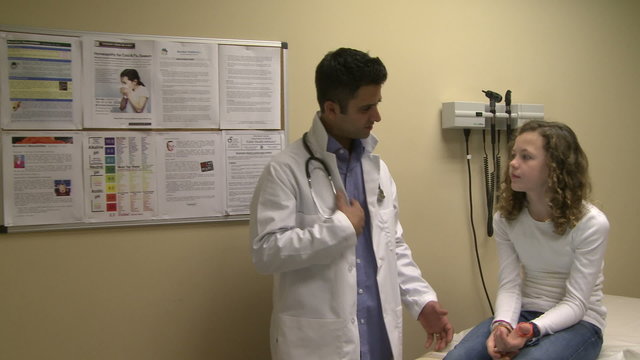 Doctor has friendly discussion with young patient