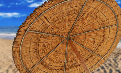 A reed sun umbrella symbolizing vacationing in summer