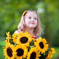 Little girl with sunflowers