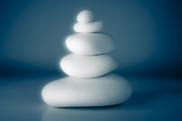 White stones stacked against a blue background - blurred and ton