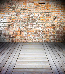 Old interior with colored brick wall and wooden floor