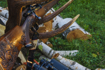 Rifle with hunting knife and binocular