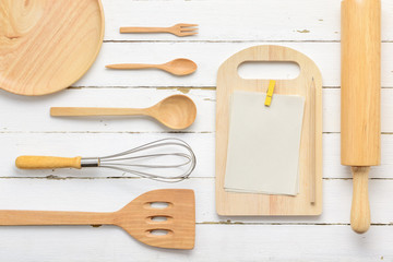 Notebook to write the list of menu and wooden kitchen utensils o