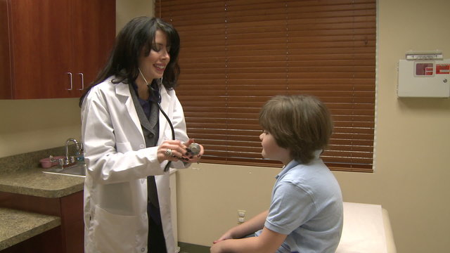 Female doctor begins pediatric checkup