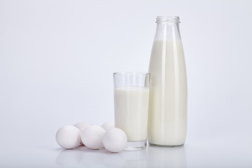 Open bottle milk, glass of milk and eggs