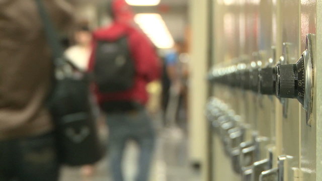 Close up of lockers with students in background