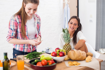Women preparing dinner in a kitchen concept dieting healthy food