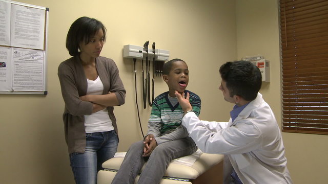 Doctor diagnoses a young boy