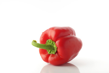 High Resolution Image Of Red Bell Pepper With Green Stem over White Background, Shot In Studio.