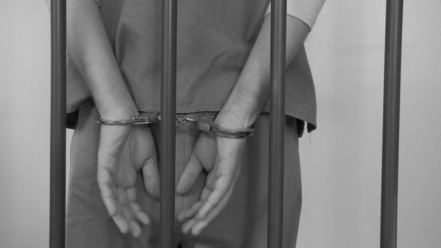 Guard Removes Inmates Handcuffs