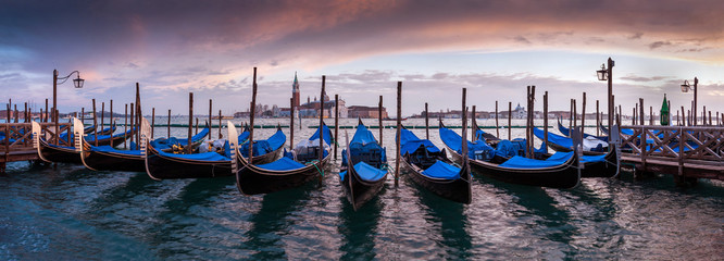 A row of gondolas parked beside the Riva degli Schiavoni in Venice, Italy - 92388931