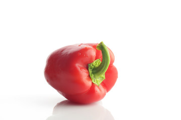 High Resolution Image Of Red Bell Pepper With Green Stem over White Background, Shot In Studio.
