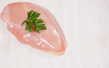 Food background of raw chicken breast at the wooden board with copy space