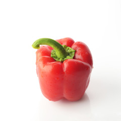 High Resolution Image Of Red Bell Pepper With Green Stem over White Background, Shot In Studio.