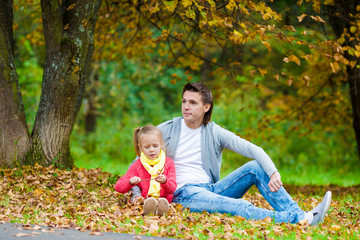 Naklejka na ściany i meble Adorable little girl with father in beautiful autumn park