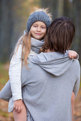 Fototapeta premium Adorable little girl with father in beautiful autumn park
