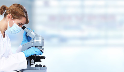 Doctor woman with microscope.