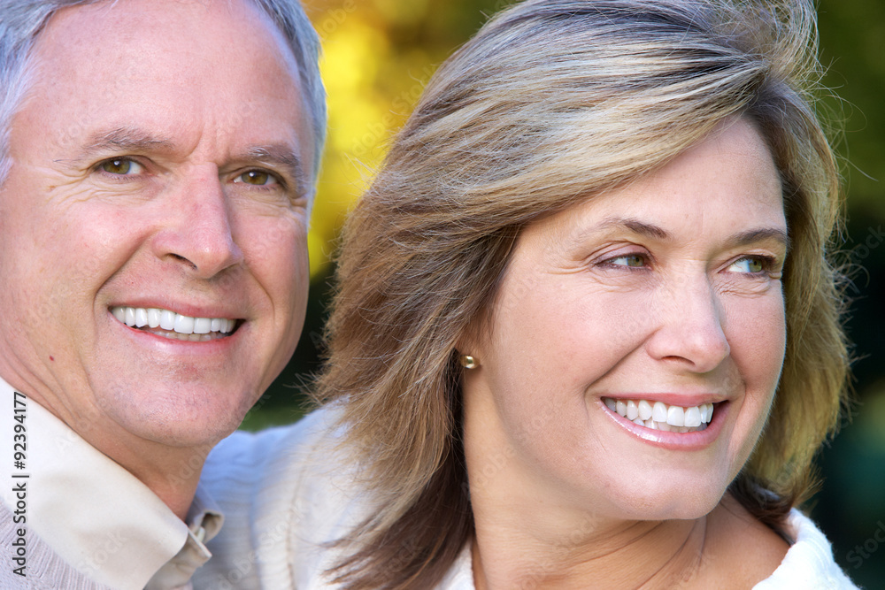 Poster happy senior couple in park.