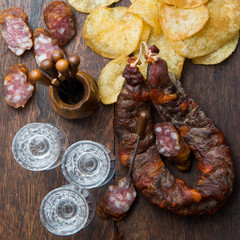 Vodka with chorizo sausage and chips potatoes