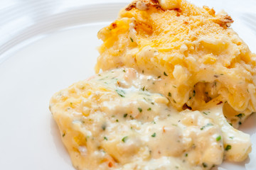 Close-up of a fish pie on a white plate