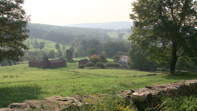 Looking down a hill to a farm on a misty day