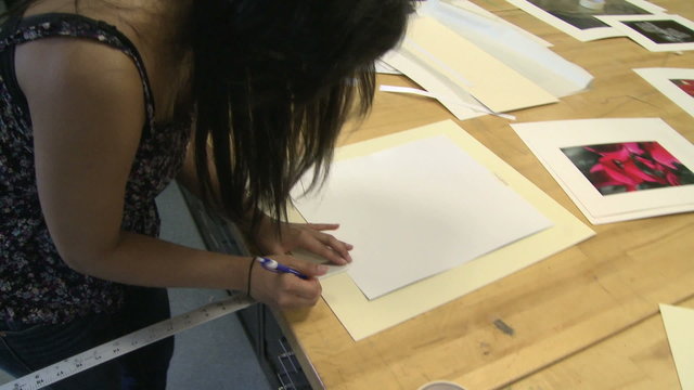 Young girl working on framing a picture