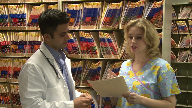 Doctor and Nurse discuss patient's chart