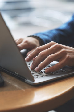 Close up shot of hands typing on laptop 