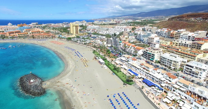 Beautiful aerial flight over Los Cristianos beach (Playa de las America), Canary Island Tenerife, Spain