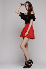 Fototapeta premium woman in red dress with long curly hair